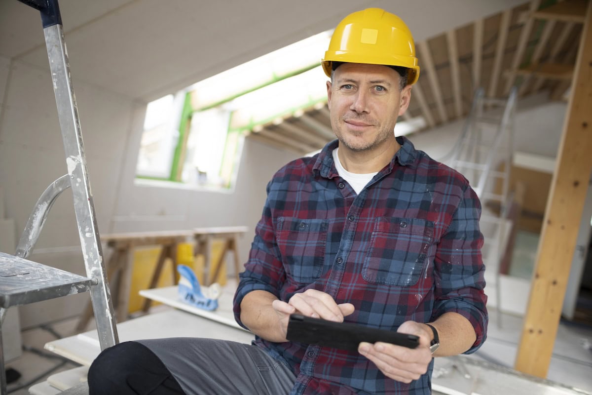 Confident contractor business owner using digital tools to manage growth systems and operations