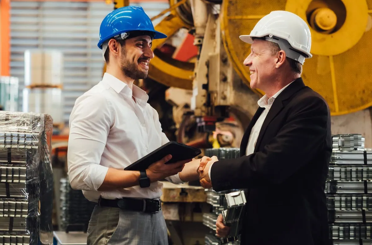 Marketing consultant and contractor business owner shaking hands on fractional CMO partnership agreement