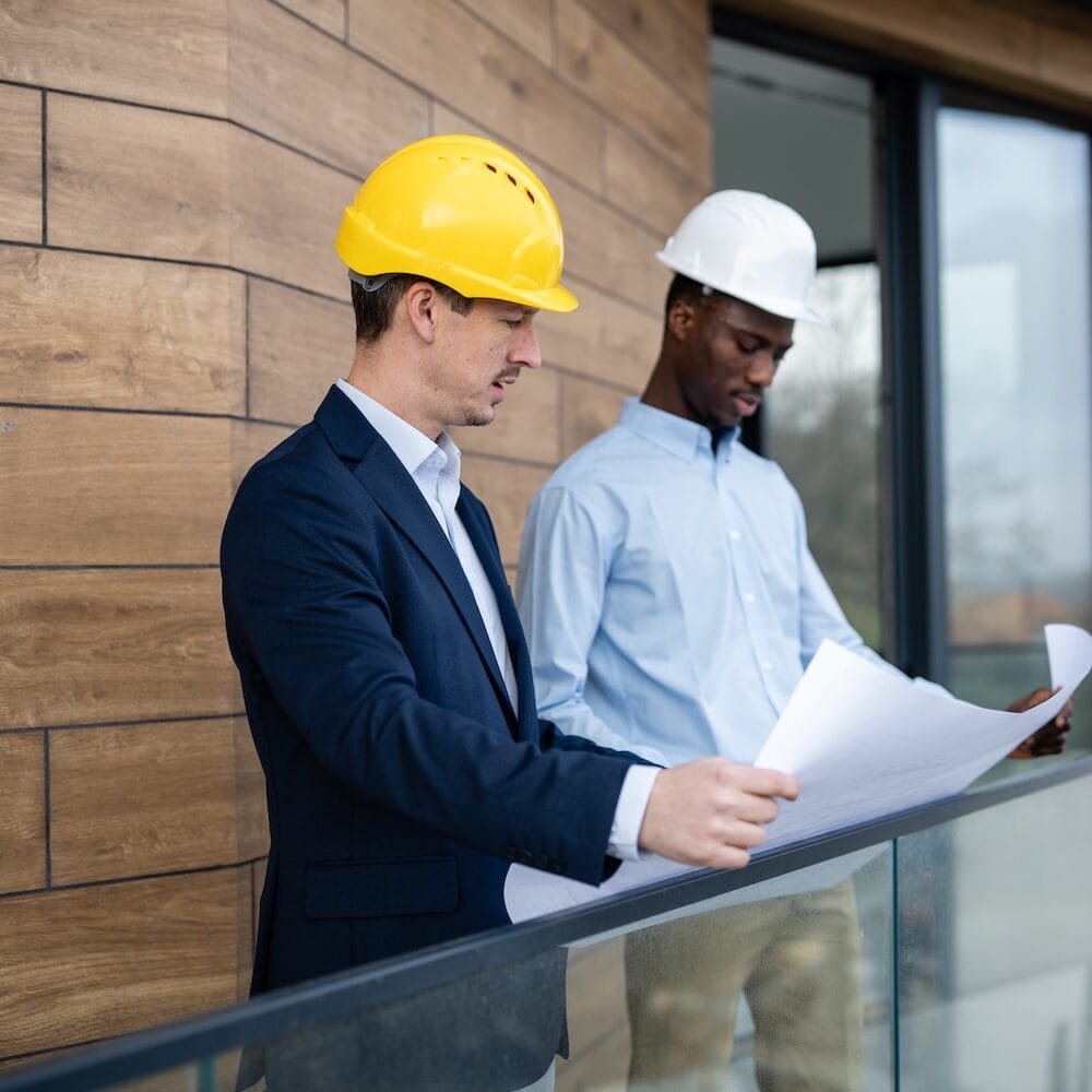 Construction project managers reviewing plans representing contractor growth strategy